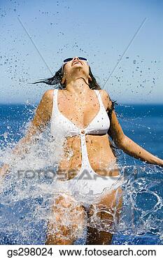 Stock Photo - woman splashing 
in sexy swimsuit. 
fotosearch - search 
stock photos, 
pictures, images, 
and photo clipart