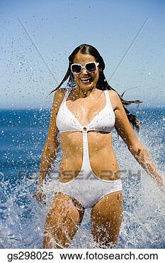 Stock Image - woman splashing 
in sexy swimsuit. 
fotosearch - search 
stock photos, 
pictures, images, 
and photo clipart