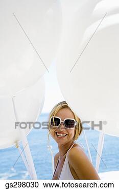 Stock Photography - woman in sunglasses 
with balloons. 
fotosearch - search 
stock photos, 
pictures, images, 
and photo clipart