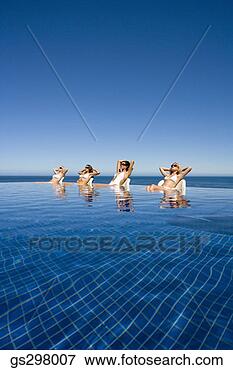 Picture - women lounging 
in infinity pool. 
fotosearch - search 
stock photos, 
pictures, images, 
and photo clipart