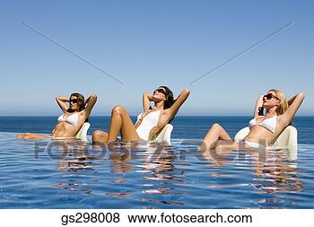 Stock Photo - women lounging 
in infinity pool. 
fotosearch - search 
stock photos, 
pictures, images, 
and photo clipart