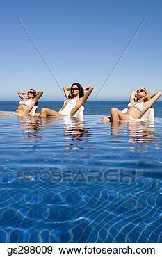 Stock Photograph - women lounging 
in infinity pool. 
fotosearch - search 
stock photos, 
pictures, images, 
and photo clipart