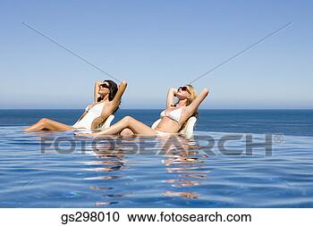 Stock Photography - women lounging 
in infinity pool. 
fotosearch - search 
stock photos, 
pictures, images, 
and photo clipart