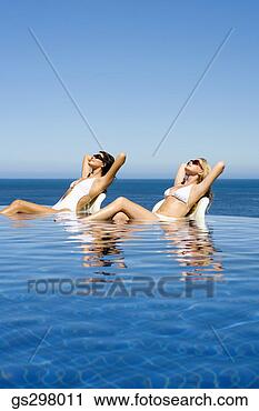 Stock Photography - women lounging 
in infinity pool. 
fotosearch - search 
stock photos, 
pictures, images, 
and photo clipart