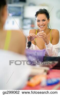 Stock Photo - woman applying 
makeup. fotosearch 
- search stock 
photos, pictures, 
images, and photo 
clipart