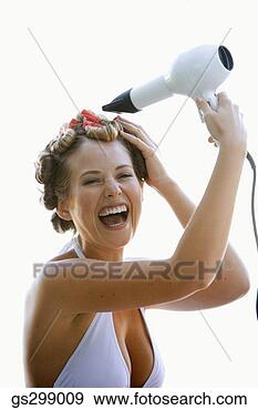 Stock Photograph - woman blow-drying 
hair. fotosearch 
- search stock 
photos, pictures, 
images, and photo 
clipart