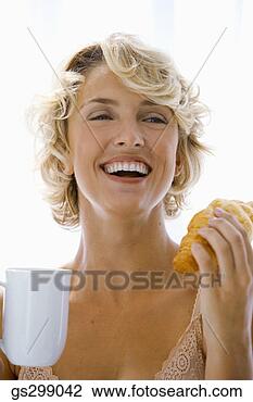 Stock Photo - woman with croissant 
and beverage. 
fotosearch - search 
stock photos, 
pictures, images, 
and photo clipart