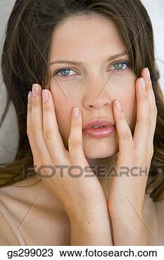 Stock Photo - woman with hands 
on face. fotosearch 
- search stock 
photos, pictures, 
images, and photo 
clipart