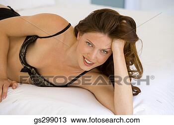 Stock Photo - woman in lingerie 
lying down. fotosearch 
- search stock 
photos, pictures, 
images, and photo 
clipart