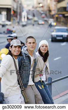Stock Photograph - friends standing 
near street. fotosearch 
- search stock 
photos, pictures, 
images, and photo 
clipart