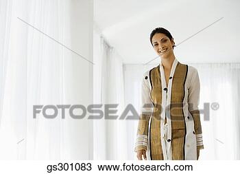 Stock Photo - cheerful woman 
standing indoors. 
fotosearch - search 
stock photos, 
pictures, images, 
and photo clipart