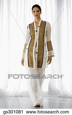Stock Photography - serious woman 
standing indoors. 
fotosearch - search 
stock photos, 
pictures, images, 
and photo clipart