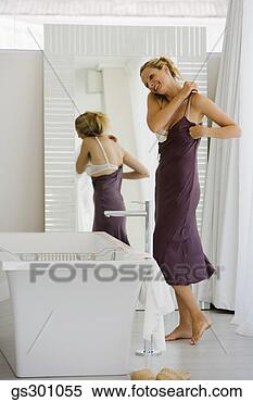 Stock Image - woman dressing 
by a mirror. fotosearch 
- search stock 
photos, pictures, 
images, and photo 
clipart