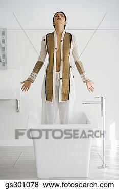 Stock Photo - woman standing 
in a bathtub. 
fotosearch - search 
stock photos, 
pictures, images, 
and photo clipart