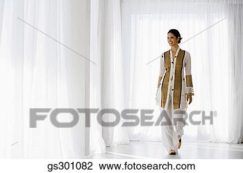 Stock Photo - woman standing 
indoors. fotosearch 
- search stock 
photos, pictures, 
images, and photo 
clipart
