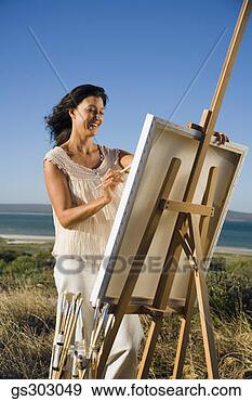 Stock Photograph - painter outdoors 
with easel and 
supplies. fotosearch 
- search stock 
photos, pictures, 
images, and photo 
clipart