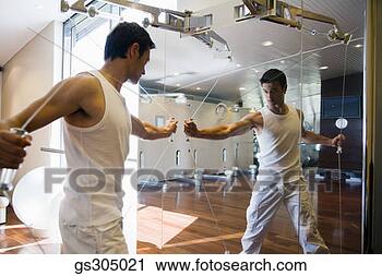 Stock Photography - man exercising 
in mirror. fotosearch 
- search stock 
photos, pictures, 
images, and photo 
clipart