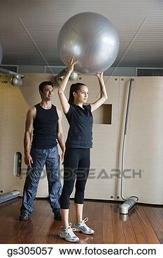 Picture - trainer and woman 
exercising with 
fitness ball. 
fotosearch - search 
stock photos, 
pictures, images, 
and photo clipart