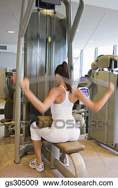 Stock Photograph - woman exercising 
in gym. fotosearch 
- search stock 
photos, pictures, 
images, and photo 
clipart