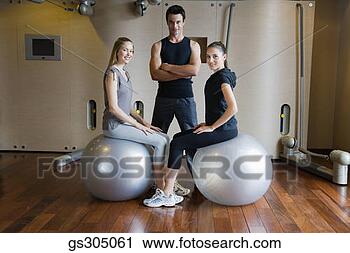 Stock Photography - women exercising 
with fitness balls 
and trainer. fotosearch 
- search stock 
photos, pictures, 
images, and photo 
clipart