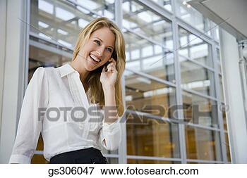 Picture - smiling businesswoman 
on cell phone. 
fotosearch - search 
stock photos, 
pictures, images, 
and photo clipart