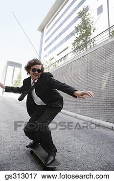 Picture - businessman riding 
skateboard. fotosearch 
- search stock 
photos, pictures, 
images, and photo 
clipart