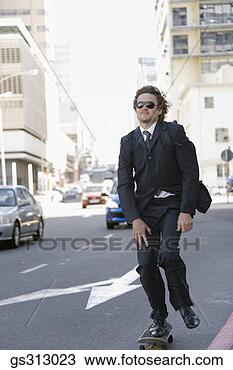 Stock Photo - businessman riding 
skateboard along 
city street. fotosearch 
- search stock 
photos, pictures, 
images, and photo 
clipart