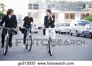 Stock Photo - businesspeople 
riding bicycles 
in city street. 
fotosearch - search 
stock photos, 
pictures, images, 
and photo clipart