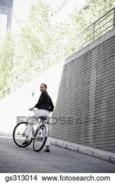 Stock Photo - businesswoman 
riding bicycle. 
fotosearch - search 
stock photos, 
pictures, images, 
and photo clipart