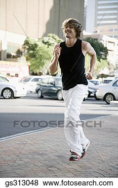 Stock Photo - man jogging near 
city street. fotosearch 
- search stock 
photos, pictures, 
images, and photo 
clipart