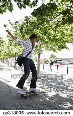 Stock Image - man riding skateboard 
on sidewalk. fotosearch 
- search stock 
photos, pictures, 
images, and photo 
clipart