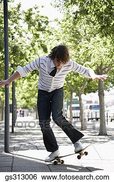 Stock Photo - man riding skateboard 
on sidewalk. fotosearch 
- search stock 
photos, pictures, 
images, and photo 
clipart