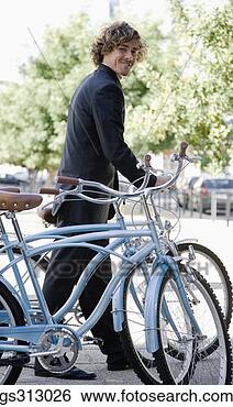 Stock Photo - smiling businessman 
with bicycles. 
fotosearch - search 
stock photos, 
pictures, images, 
and photo clipart