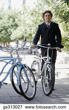 Picture - smiling businessman 
with bicycles. 
fotosearch - search 
stock photos, 
pictures, images, 
and photo clipart