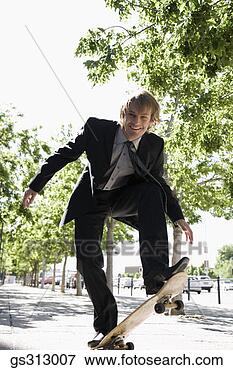 Picture - smiling businessman 
riding skateboard. 
fotosearch - search 
stock photos, 
pictures, images, 
and photo clipart