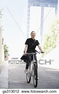 Stock Photo - smiling businesswoman 
riding bicycle. 
fotosearch - search 
stock photos, 
pictures, images, 
and photo clipart