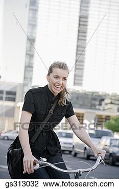 Stock Photo - smiling businesswoman 
riding bicycle. 
fotosearch - search 
stock photos, 
pictures, images, 
and photo clipart