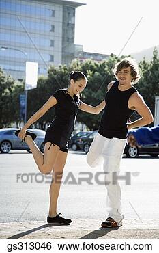 Stock Photo - smiling couple 
stretching next 
to city street. 
fotosearch - search 
stock photos, 
pictures, images, 
and photo clipart