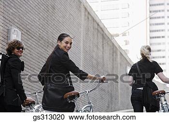 Stock Photography - smiling people 
with bicycles. 
fotosearch - search 
stock photos, 
pictures, images, 
and photo clipart