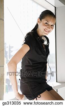 Stock Image - smiling woman 
with headphones. 
fotosearch - search 
stock photos, 
pictures, images, 
and photo clipart
