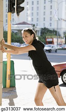 Picture - smiling woman 
stretching near 
city street. fotosearch 
- search stock 
photos, pictures, 
images, and photo 
clipart