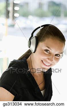 Stock Photo - smiling woman 
wearing headphones. 
fotosearch - search 
stock photos, 
pictures, images, 
and photo clipart