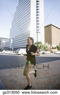 Stock Photography - woman jogging 
near city street. 
fotosearch - search 
stock photos, 
pictures, images, 
and photo clipart