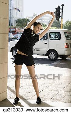 Stock Photograph - woman stretching 
near city street. 
fotosearch - search 
stock photos, 
pictures, images, 
and photo clipart