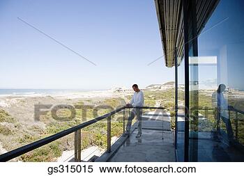 Stock Image - man on balcony. 
fotosearch - search 
stock photos, 
pictures, images, 
and photo clipart
