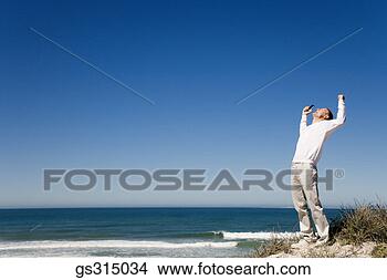 Stock Photo - man at beach with 
arms outstretched. 
fotosearch - search 
stock photos, 
pictures, images, 
and photo clipart