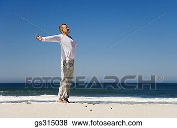 Stock Photo - man on beach with 
arms outstretched. 
fotosearch - search 
stock photos, 
pictures, images, 
and photo clipart
