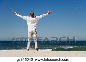 Stock Photography - man on beach with 
arms outstretched. 
fotosearch - search 
stock photos, 
pictures, images, 
and photo clipart