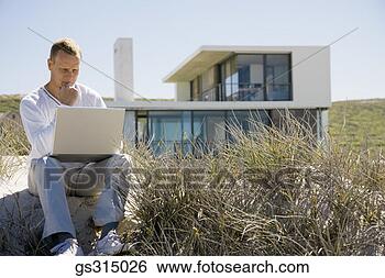 Stock Photo - man at beach with 
laptop. fotosearch 
- search stock 
photos, pictures, 
images, and photo 
clipart
