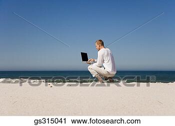 Stock Photography - man at beach with 
laptop. fotosearch 
- search stock 
photos, pictures, 
images, and photo 
clipart